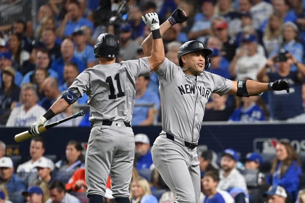 Yankees players celebrating victory, after a hard fought match and after heroics of Stanton and Weaver.